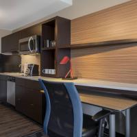 a kitchen with a desk and a chair in a room at TownePlace Suites by Marriott St. Louis Edwardsville, IL