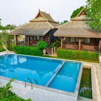 a villa with a swimming pool in front of a house at มนต์เมืองเชียงใหม่ รีสอร์ต Monmuang Chiangmai Resort, Hang Dong