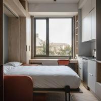 a bedroom with a large bed and a large window at Stylish and Modern Studios in Dún Laoghaire, DUBLIN - SK, Dublin