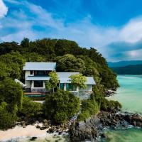 a house on a rocky island in the ocean at JA Enchanted Island Resort Seychelles, Round Island