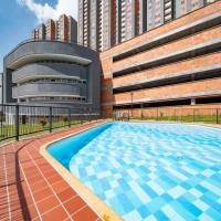 a large swimming pool in front of a building at habitación confortable, Medellín