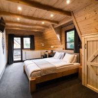 a bedroom with a bed in a wooden cabin at Chocholowska Zohylina pokoje i domek, Chochołów