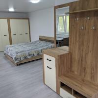 a bedroom with a bed and a dresser with a mirror at Villa Raut, Orhei