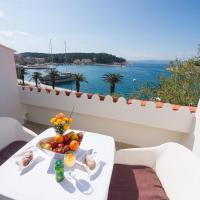 a table with a bowl of fruit on a balcony at Hotel Biokovo, Makarska