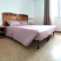 a bedroom with a large bed and a chair at Agriturismo Le Crede 1930, Portogruaro