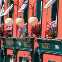 a row of buildings with flower boxes and lights at Bridge Hotel, Arklow