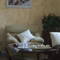 a living room with a chair and a coffee table at Il Cortile Della Nonna, Chieri