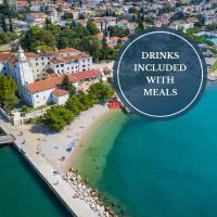 an overhead view of a beach with a sign that reads drinks included with meals at Hotel Kastel, Crikvenica