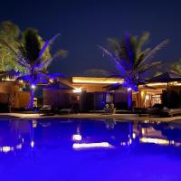 a swimming pool at night with blue lights at Hôtel La Belle Etoile, Saly Portudal