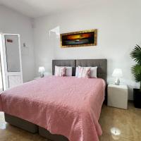 a bedroom with a bed and a couch and a plant at Estúdio Home away from home, Caniçal