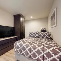 a bedroom with a bed and a flat screen tv at Troutdale Tranquility