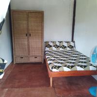 a bed sitting in a room with a cabinet at Klay's tiny home, San Isidro