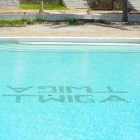 a swimming pool with a graffiti on the water at Twiga Beach Resort, Watamu