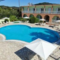 a large swimming pool in front of a building at Athina Hotel, Agios Georgios Pagon