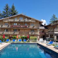 a hotel with a swimming pool in front of a building at Au Vieux Moulin, Megève