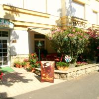 a flower shop with flowers in front of a building at Hotel Baross, Győr