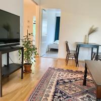 a living room with a television and a rug at Woodpecker Avenue Apartment, Turku