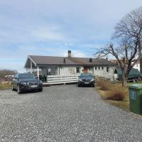 a house with two cars parked in the driveway at Hus ved Lillestr&oslash;m by
