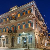 a large building with colorful windows on a street at Hotel Halaris, Ermoupoli