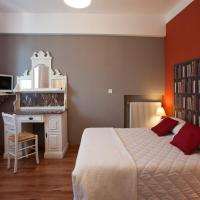 a bedroom with a large bed and a book shelf at Hôtel la Bona Casa, Collioure