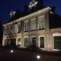 an old brick building with shuttered windows at night at Hotel Lemmer