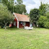 Red small cottage on Oland surrounded by grazing sheep