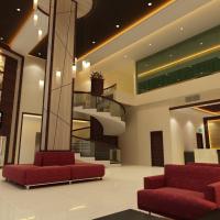 a lobby with red chairs and a spiral staircase at Hallmark Regency Hotel - Johor Bahru