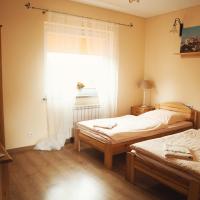 a room with two beds and a window with at Noclegi Moya Ameryka w Dolinie Baryczy, Milicz