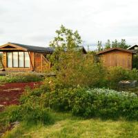 a house in the middle of a garden at Thingvellir Lake Cottage, Veiðilundur