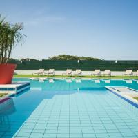 a pool with chairs and a palm tree next to it at Atlanthal, Anglet