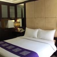 a bedroom with a large white bed in a room at Metro Hotel Jababeka, Cikarang