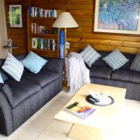 a living room with two couches and a coffee table at Lavendula Garden Cottage, Burnt Pine