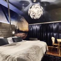 a bedroom with a large bed and a chandelier at Original Sokos Hotel Vaakuna Rovaniemi