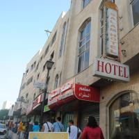 people walking on a street in front of a hotel at Al Salam Hotel, Bethlehem