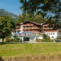 a hotel on the side of a river at Parkhotel Sonnenhof, Oberammergau