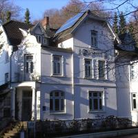 a large white house with a roof at Hotel Villa im Steinbusch, Malente
