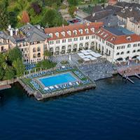 an aerial view of a building with a pool in the water at Hotel San Rocco, Orta San Giulio
