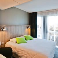 a hotel room with a bed and a large window at Campanile Rennes Centre - Gare