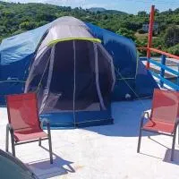 Rooster Run Camping is a - rooftop & elevated camping experience! Incredible views of The Rain Forrest and Culebra across the Atlantic Ocean - Tents, towels, comfortable Air Beds, Warm Shower-Central Location- 5 beaches -25 min walk & Ferry is 20 min, hotel em Vieques