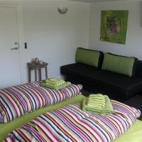 a living room with two beds and a couch at Ikast Bed & No Breakfast