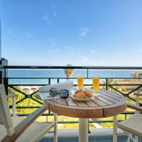 a table with a plate of food on a balcony at Plaza Hotel, Zakynthos