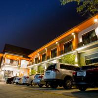 a row of cars parked in front of a building at Aziss Boutique Hotel - SHA Plus, Phitsanulok