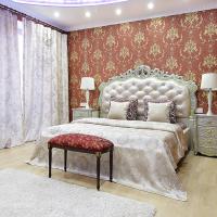 a bedroom with a large bed with a red wall at PaulMarie Apartments on Mayakovskogo, Brest