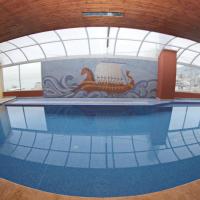 a large swimming pool in a building with a mural at Madisson Hotel, Jounieh