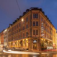 a large brick building on a city street at night at Hotel Central, Innsbruck