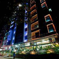 a building with blue lights on the side of it at Well Park Residence Boutique Hotel & Suites, Chittagong