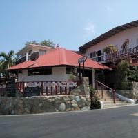 a building with a red roof on a street at Hotel Contadora