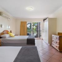 a bedroom with a bed and a dresser and a window at Glenmore Tavern, Rockhampton