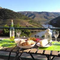 a table with a plate of food and a bottle of wine at Quinta da Galeira, Pinhão