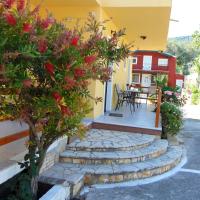 a house with stairs leading to a patio with flowers at Maria Apartments - Roumanis, Liapades